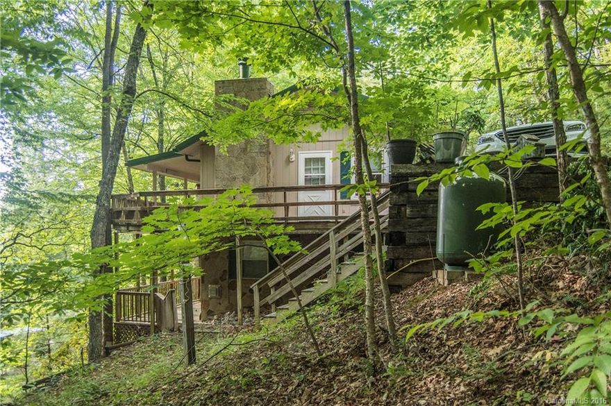 Relax in the rocking chair on 2 covered porches at this lovingly cared for Mountain Retreat.Build family memories while listening to the stream & pleasant Mtn Summer weather. Privately located on the Mountain but close to town. Features wonderful & comfortable main floor living area. Lower level includes guest quarters for your family & friends to privately enjoy. Home has been tastefully updated & includes replacement windows, newer metal roof & paint. Don't miss this special Mountain gem!