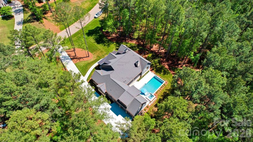 Welcome to 6223 Chimney Bluff Road! One of the best lots at Riverchase Estates. This isn't just a home; it’s a breathtaking 1.63-acre sanctuary where architectural elegance meets the raw, untouched beauty of nature. A rare double lot that backs directly onto 500 acres of protected conservation land, this estate offers the ultimate luxury: complete privacy.
While the interiors are a masterclass in design, the outdoor living space is where your summer dreams truly come to life. Step out onto the massive 34x16 covered screened porch, where you can grill at the island or curl up by the wood-burning fireplace while looking out over your resort-style oasis. The centerpiece is a magnificent 18x38 heated pool and spa, finished with exquisite marble pavers.
Whether you are cooling off on a hot Carolina afternoon or hosting a sunset poolside gathering, this space is ready for you to create a lifetime of memories.
In addition, the encapsulated crawl space with a dehumidifier ensuring structural perfection and do not forget the direct to the river walk access that connects you to a truly outdoors experience.
This is more than a residence—it is "The One" you’ve been waiting for.