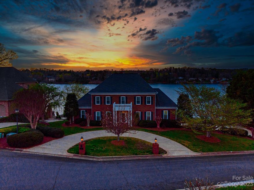 Moores Ferry Waterfront gated community "Hickory Riviera on Lake Hickory" w/ classical southern colonial architecrual features, stately columns w/ expansive sweeping main channel lake views. Foyer boasting grand Georgian staircase, library, formal dining, soaring ceiling height, continuous open floor plan throughout coffered ceilings, moldings, bold arches, hardwood, lrg great room, FP, book shelves, wall of french doors opening onto columned patio-ideal for entertaining w/ sunsets & boating, gourmet chef's eat in dream kitchen, viking appliances, main level en-suite, lrg bath, steamer shower for two, double dressing vanity, beautiful Lake views. . 4 bedrooms upper level,  lower level living w/kit, bedroom. bath, rec room w/ fp opens onto patio. 3 car lrg garage/side driveway. Walk-way to floating dock, deck, lifts, fenced back yard. Amenities: Club house, pool, boat slips (sale only) Close to downtown Hickory, schools, shopping, medical, parks.  Truly one of finest neighborhoods.