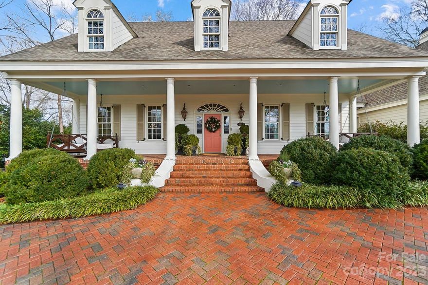 Welcome home to this low country stunner designed by famed architect William Poole. Outdoor living is as sweet as the iced tea you will be serving while enjoying the privacy and exquisite beauty only established and mature landscaping can provide. The deep and expansive front porch with it's flickering gas lanterns beckon you to sit and stay. The rear covered patio, with its fire place and square footage will be the private gathering place of many family events. Once you enter this traditional beauty you immediately feel the love and craftsmanship that this house has benefitted from. Expansive moldings and luxury finishes set the tone. The Primary suite on the mail level is generously sized offering a abundance of natural light. The Primary suite offers two expansive closets, one that has to be seen to be believed. While the home is open, formal spaces create a intimate space for gatherings which include two fire places. This home must be viewed to appreciate it's beauty and charm.