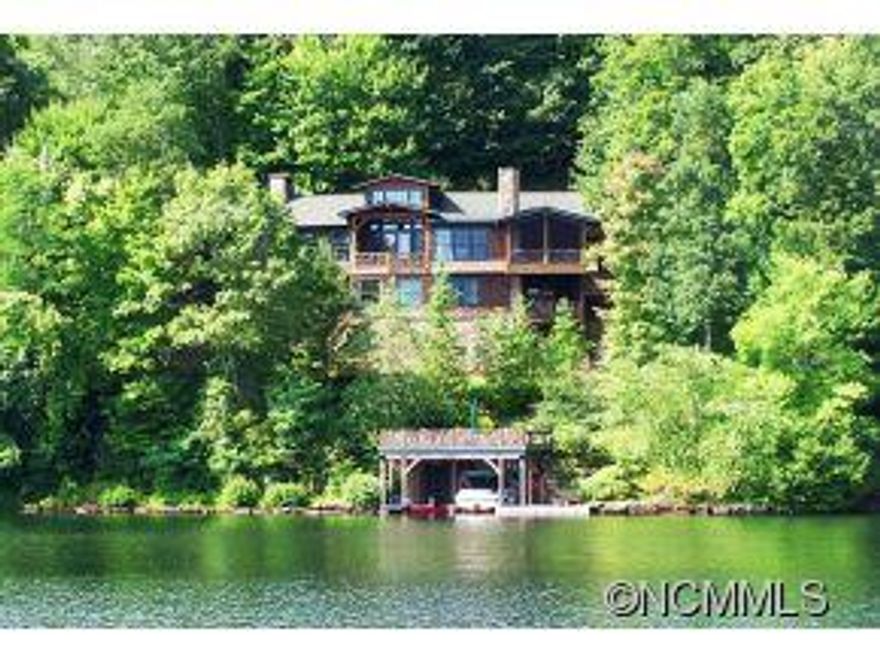Price dropped 200k on this magnificent Frank Lloyd Wright inspired lakefront home.Every curve of wood,every Tennessee Field Stone wall,every rafter feels a part of the natural world, drawing the eye to the lake.Sitting on two lots,the presence is breathtaking, offering a big view of lake Toxaway. Garage plans and initial permitting in place.Everything is of the highest quality.Square footage per appraisal and includes heated and cooled workshop