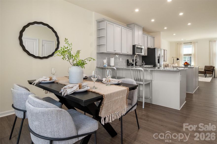 Experience urban LoSo living at its best—just steps from the light rail for unbeatable convenience. This move-in ready home features luxury vinyl plank flooring, stylish light gray 42" cabinetry, gray subway tile backsplash, granite countertops and custom shades! Enjoy a private terrace perfect for relaxing or entertaining, along with a rare 2-car tandem garage offering plenty of storage. Inside, the bright and open layout is complemented by neutral paint throughout. The spacious kitchen shines with a large island, stainless steel appliances and abundant storage, including a pantry and additional utility closets. The split-bedroom floor plan provides ideal flexibility for roommates, guests or a home office. All appliances convey—including the refrigerator and in-unit stackable washer and dryer—making this an easy, turnkey opportunity. Enjoy a energy-efficient home with two HVAC zones and two smart thermostats you can control from your phone, low HOA dues, an unbeatable light rail location and quick access to major roadways. Priced below tax value—this opportunity won’t last!