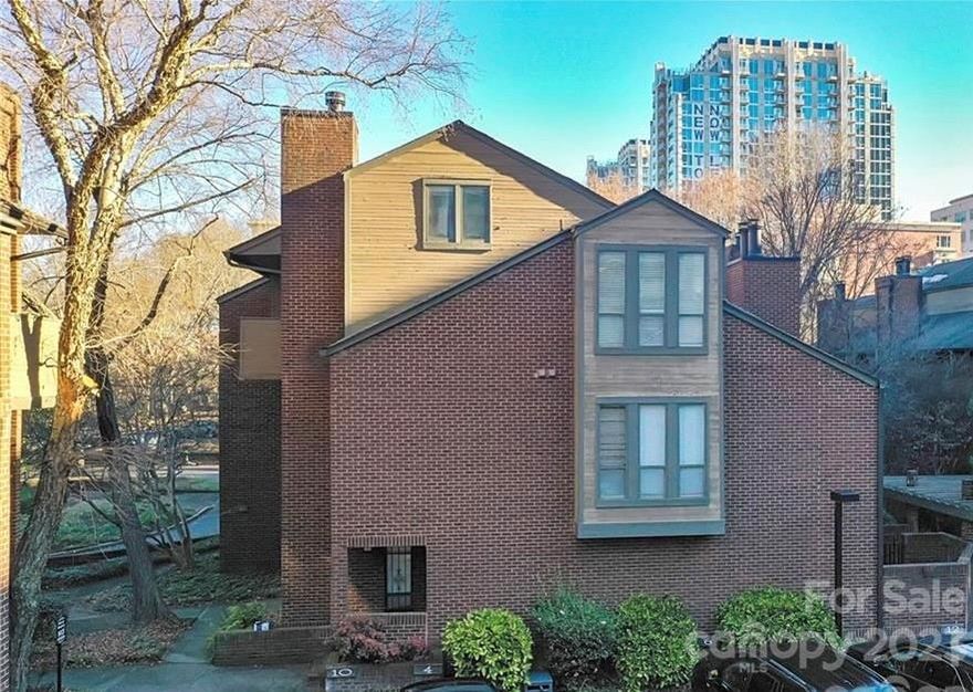 LOCATION, LOCATION, LOCATION…Lowest priced 2 bedroom in Uptown! Freshly painted and move-in ready. These units rarely come up for sale. Located in the heart of Fourth Ward just blocks away from Panther’s Stadium and BB&T ballpark.  Convenient to the uptown parks, restaurants and all that Uptown has to offer.  Ground level private entrance with private courtyard and storage shed in back of unit.  This home features hardwoods downstairs with open floor plan, stainless steel appliances, double oven, granite counters, tiled backsplash and wood-burning fireplace.  Upstairs offers 2 bedrooms and 1 bath with 2 separate sink vanity areas as well as 2 laundry and storage closets.  HVAC new in 2022. Washer/dryer and refrigerator to convey with purchase. One assigned parking space (#7) with additional resident parking available directly behind on 8th Street with permit.  2 hour visitor parking available in the same lot.