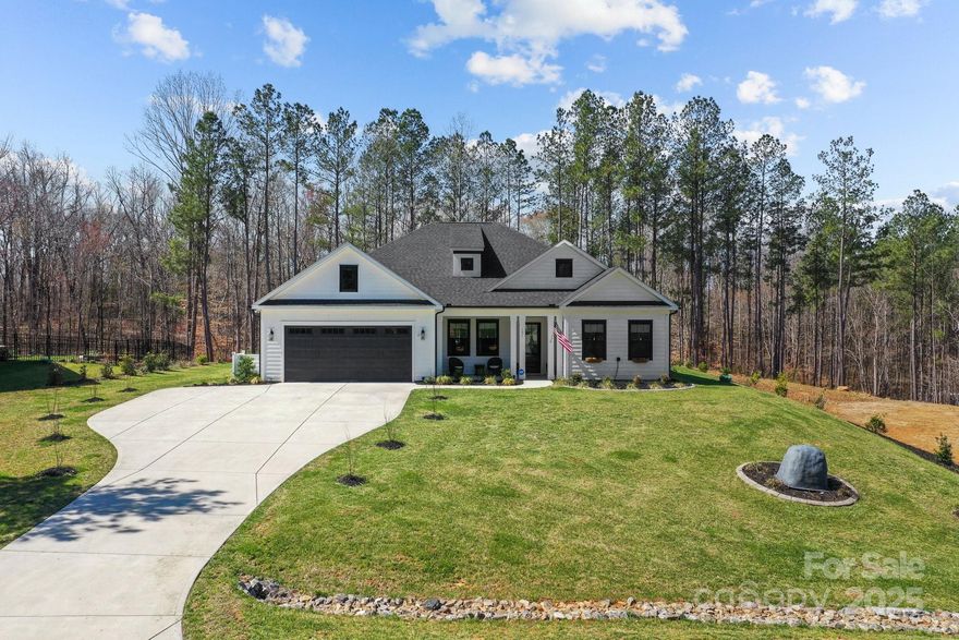 Indulge in the finest luxury living with this exceptional ranch home built in 2022 on over an acre, blending elegance, comfort, and modern convenience. The stunning primary suite offers a private retreat with a soaker tub and massive tile shower & large closet. With a flex room and a bonus room currently used as a 3rd guest bedroom, it offers versatile space for your family or guests. A bright all-season sunroom invites year-round enjoyment, with sliding doors throughout that lead you to a travertine deck and saltwater pool with a cascading waterfall, all surrounded by lush, manicured landscaping. The gourmet kitchen boasts a large quartz island and leathered granite countertops, custom built-ins, and a wine fridge, perfect for entertaining. Thoughtful upgrades include a whole-house 24kW generator, custom window treatments, an extended third-car driveway, and a security system with cameras. A truly sophisticated sanctuary, this home defines the lifestyle you’re looking for.
