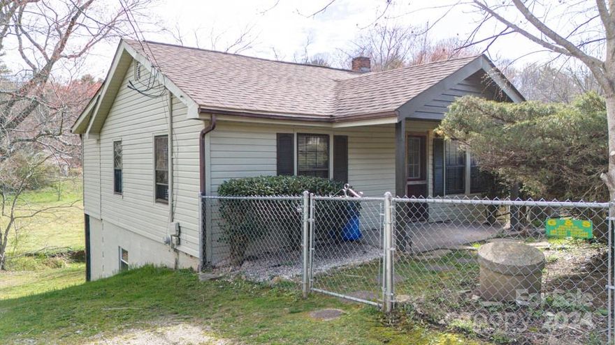 Discover the epitome of tranquil living in this charming streamside bungalow nestled on a spacious .292-acre lot with a sun-drenched, level yard. Impeccably maintained with a new heat pump system installed in 2020,  this inviting 2-bedroom, 1-bathroom home offers seamless move-in readiness and is ideally situated on the coveted East side of Candler.  Step onto the covered deck and indulge, complete with a vintage clawfoot tub just steps away from the gently flowing stream, providing the perfect oasis for relaxation and rejuvenation.  Convenience meets nature with this location, offering easy access to the renowned Blue Ridge Parkway just 15 minutes away, while the vibrant community of West Asheville is a mere 10-minute drive, and downtown Asheville is just a scenic 20-minute commute.  Experience the harmony of countryside living with urban amenities at your fingertips in this idyllic retreat.