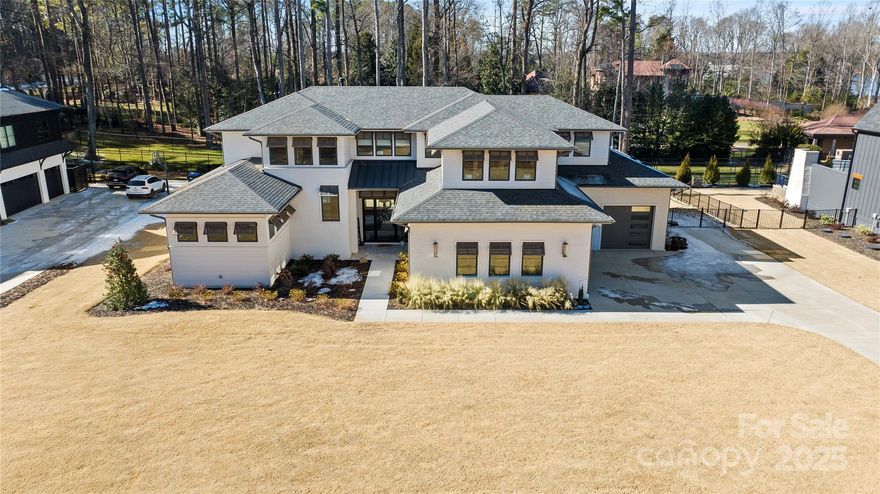 Welcome to Helms Port on Lake Norman! A small quaint neighborhood with no HOA, along with that private country-like setting right in the heart of Mooresville. This like new home was built in 2024 and has barely been lived in. Built by Titan Custom Homes so it is top of the line construction. This stunning modern home consists of 4 bedrooms and 5.5 bathrooms, bonus room, and additional room that can be used as an office or another bedroom. All 5 rooms have their own private full bathroom. Step outside to the top-of-the-line pool deck with a covered patio that is perfect for entertaining or simply relaxing. Indulge in the custom saltwater pool/spa combo while having water views of Lake Norman.