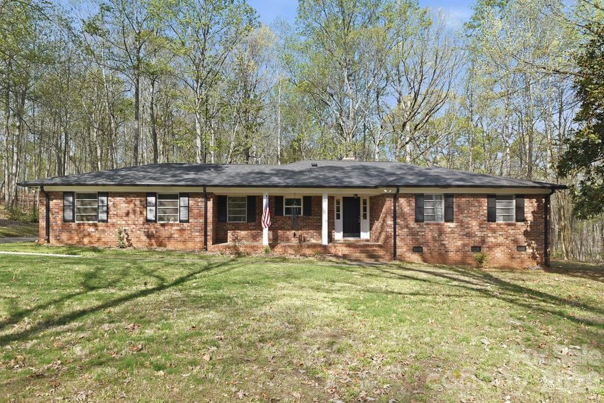 If you have been searching for the impossible—sprawling acreage, total privacy, and a seamless city commute—your search ends here. Tucked away at the end of an exclusive three-home cul-de-sac, this handsome mid-century ranch sits on over 2.5 spectacular acres. Whether you dream of a private wooded buffer, a multi-generational compound, or exploring subdivision potential, this land offers a "slice of heaven" where the city has grown up around you, but your peace remains undisturbed.

Interior Highlights:
The home’s classic character is anchored by gorgeous, newly refinished hardwood floors that flow through a spacious, sun-drenched layout. Centered around a classic living room fireplace, the main living area feels both grand and cozy. The retreat-style Primary Suite is exceptionally large for the era and features its own private wood-burning fireplace—the perfect spot to unwind. Two additional well-proportioned bedrooms share a full hall bath, providing plenty of space for family, guests, or a dedicated home office.

Indoor-Outdoor Living:
Transition seamlessly to the outdoors via the expansive back porch. Equipped with sliding glass doors that can be fully opened to the breeze, this versatile space overlooks your private, wooded estate. Because the lot is naturally wooded, you enjoy the majesty of massive acreage without the burden of endless lawn maintenance.

Unmatched Peace of Mind:
Buy with absolute confidence knowing all the "big things" are already done:

Brand New HVAC (2026)

Extensive Electrical Upgrades (2023)

New Water Heater (2022)

New Roof (2019)

Complete with a two-car rear-load garage (ideal for a workshop or hobby space), this property is the ultimate urban oasis.

Don’t miss this once-in-a-generation opportunity to own significant acreage in the city. Schedule your private tour today and see why this is the sanctuary you’ve been waiting for!