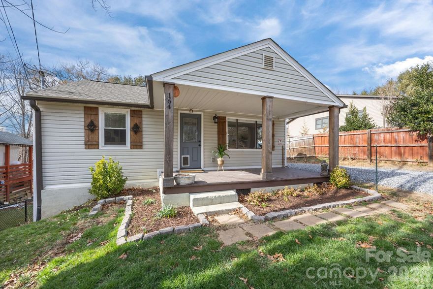 This cute-as-a-button 1950's cottage offers a flat, usable yard and an inviting front porch perfect for relaxing. Inside, this move-in ready home features a beautifully updated kitchen with granite countertops and stainless steel appliances, along with renovated bathrooms finished with matching granite counters for a cohesive, modern feel.

The flexible layout offers one bedroom and a full bath on the main level, plus two bedrooms (or flex space) and bath ideal in the walkout basement, which includes both interior and exterior access. A main-level mudroom/laundry room adds everyday convenience and a new heat pump in 2023 offers peace of mind.

Just minutes from the heart of West Asheville’s dining and shopping, as well as the nearby Ingles and Lowe’s, this home combines character with thoughtful updates in a highly convenient location.