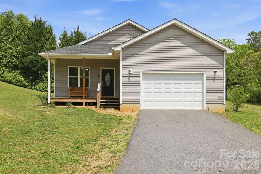 Charming and well maintained 2 bedroom, 2 bath home which offers 1,240 sq ft of comfortable living with a spacious open floor plan perfect for everyday living and entertaining. The home features a bright living area, lovely kitchen area, and a dedicated laundry space for added convenience. An attached one-car garage provides easy access and extra storage.

Enjoy peaceful outdoor living from the covered front porch or relax on the small covered back porch overlooking the beautiful cleared lot. Ideally located just minutes from Mars Hill University and the charming riverside town of Marshall. Conveniently situated approximately 25 minutes northwest of Asheville, offering easy access to shopping, dining, and entertainment while maintaining a quiet, scenic setting. 

Perfect as a primary residence, mountain retreat, or investment opportunity.