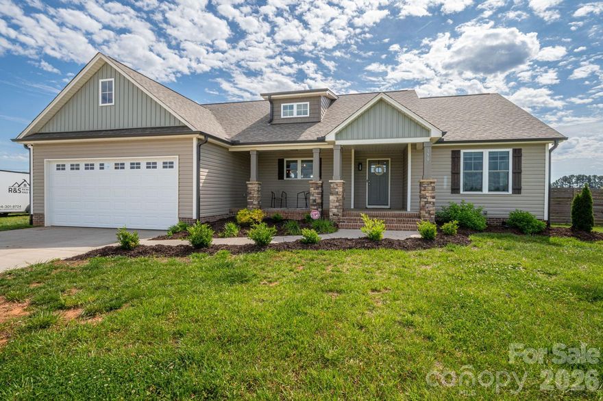 This stunning, like-new home is the total package! From the charming front porch with stone accents to the bright, open layout inside, every detail is designed to impress. The spacious living area features a cozy electric fireplace and custom touches such as built-in shelves, and a stylish accent wall. The kitchen is a showstopper with crisp white cabinetry, stainless steel appliances, lots of counterspace and an island perfect for gathering. The open dining space leads out to a spacious back deck for easy indoor-outdoor living, making this home ideal for entertaining. With stylish finishes, modern fixtures, and a warm, inviting feel throughout, this move-in ready home offers comfort, character, and convenience all in one. Enjoy peaceful surroundings while still having the benefit of nearby amenities. This move-in ready home is the perfect place to settle in and make your own.