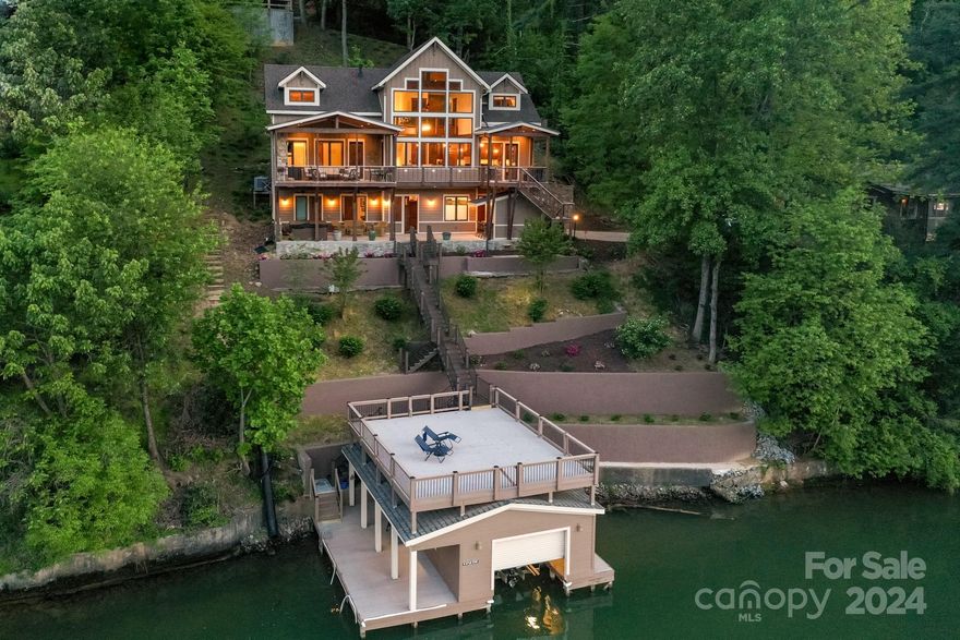 Custom built Lakefront home with spectacular views of Lake Lure and famed Rumbling Bald Mountain! This amazing lakefront home was handcrafted in 2019 and boast some 24 ft vaulted ceilings, 8 ft solid core wood doors, floor to ceiling stone fireplace and hardwood floors throughout its open designer floor plan. Just visualize yourself unwinding in the hot-tub or reclining by the outdoor fireplace while taking in some of the most spectacular views available on the lake. No detail was spared in the custom kitchen either....with its solid wood cabinetry and stainless steel appliances. You will also enjoy the large 2 car garage and elevator service to every floor. If you're looking for the best Lake Lure has to offer, this beautiful lakefront home is built to suit even the most discriminating taste. A must see at $2,790,000.