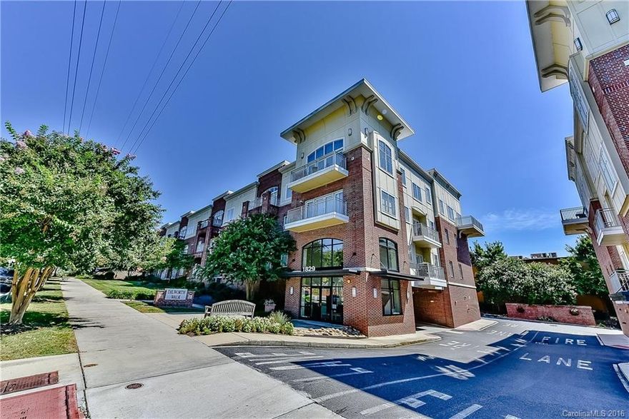 Corner unit with French doors opening to private wrap-around balcony overlooking a secluded private garden.   Open floorplan. Spacious Kitchen with island. Granite counters, tall ceilings, Maple cabinets, tile backsplash. Elegant entry Foyer. Stroll to Dilworth's finest shopping district! Reserved parking in secured garage. Elevator and lobby/mail room on ground level.