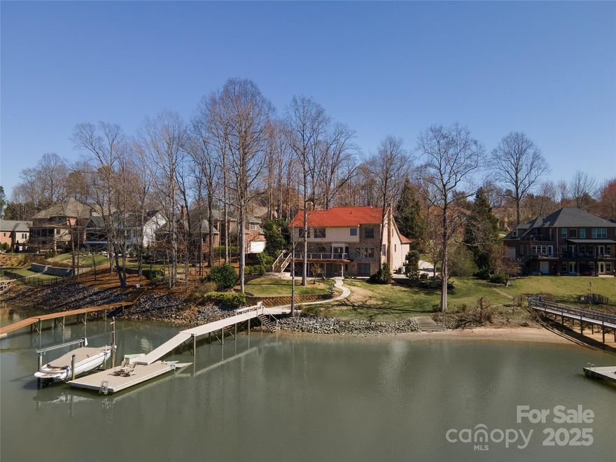 Experience waterfront living at its finest at 170 W. Maranta Dr. in Mooresville’s quaint Enclave community—a waterfront gem spanning over 4,900 sq ft. This full-brick home boasts 5 spacious bedrooms, a dedicated study, a fully furnished home theater, and a finished basement with a versatile workshop. Every window frames beautiful, long-range views of Sisters Cove, blending tranquility with natural beauty. Recent upgrades include a new roof (2022), a modern deck with sleek cable railings, a stylish paver patio and walkway leading to your private dock already equipped with a cable boat lift—perfect for outdoor enthusiasts. Nestled near the Target shopping center, great restaurants, and shopping, this location offers convenience without sacrificing serenity. Ideal for families of any size, this home seamlessly combines incredible waterfront living with an unbeatable Mooresville address. Don’t miss your chance to own this extraordinary retreat!