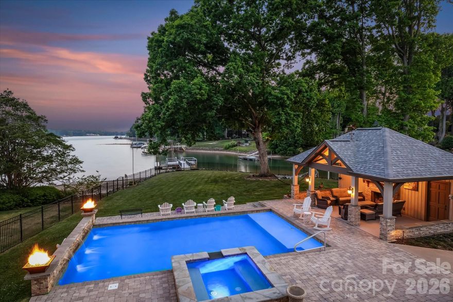 Experience the best of Lake Norman living with this well-maintained waterfront home set on a stunning .77-acre lot, offering expansive main channel views. Designed for those who value outdoor living and entertaining, this property delivers an exceptional lakeside setting while presenting a meaningful opportunity whether it's to enjoy as-is, update over time, or fully transform it to match the caliber of the lot and views. From the moment you step outside, the setting speaks for itself. The backyard unfolds into a thoughtfully designed living experience featuring a glistening saltwater pool, covered cabana with a full bath, outdoor kitchen, and multiple spaces to relax and gather. An extensive deck overlooks it all, flowing down to a lower patio and flat, lush lawn that carries you to the water’s edge. Plumbing is already in place for a future cabana bar, offering even more potential to elevate the outdoor experience. Enjoy direct lake access with a newly installed dock and pier, jet ski ramp, and an extended platform ideal for lounging or entertaining right on the water. Whether hosting or simply unwinding, this is a setting that fully embraces lake life. Originally built with a level of character and craftsmanship that’s hard to replicate, the home offers timeless details and a solid foundation for endless possibilities. Inside, you’ll find original hardwood floors, multiple fireplaces, and a primary suite on the main level. The kitchen has been remodeled, along with updates to the upper-level bathroom. The basement includes a second kitchen and full bath, providing flexibility for guests or extended living. Two tankless water heaters service the main home, with an additional unit for the pool house. The septic system was redesigned and installed in 2021 for 4 bedrooms. Whether the vision is to enjoy it as it stands today, update over time, or fully reimagine the space, the opportunity here is undeniable. Properties offering this combination of lot, views, and outdoor living are increasingly hard to find on Lake Norman.