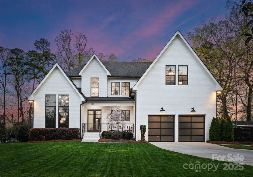 Don't miss this breathtaking, like-new Modern Farmhouse masterpiece, featuring a striking white brick exterior & unbeatable location near SouthPark, Uptown Charlotte, Private Schools, Sardis Swim & Racquet, and the McAlpine Creek Greenway. Part of the Lansdowne subdivision, this home spans 4,000+ sq ft and is packed with luxurious features. Highlights include dramatic floor-to-ceiling windows, hardwood floors & an open floor-plan. The gourmet kitchen boasts a massive waterfall-edged island, stainless steel appliances, & ceiling-height cabinetry with upper display cases. The open floor plan showcases a 2-story great room w/ fireplace. Owner’s suite on the main floor features a coffered ceiling, a luxurious spa-like bathroom & spacious walk-in closet. The upstairs loft has elegant wainscoting, a spacious bed/bonus room, & 2 large secondary bedrooms & baths. A large covered rear porch overlooks a lush, private backyard with endless possibilities for outdoor entertaining.