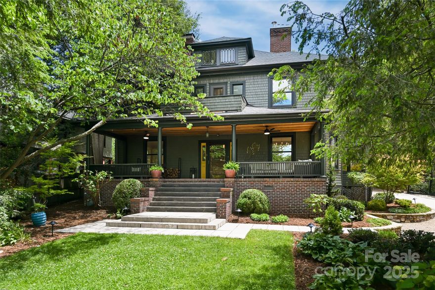 Discover the perfect balance of historic charm and modern luxury in this iconic American Foursquare, just one mile from downtown Asheville in the prestigious Grove Park neighborhood. This beautifully restored home features a chef’s kitchen with a 48” Mercury Induction Range, expansive island and folding patio doors that open to a meticulously landscaped private patio bringing the outside in. Original details include five working fireplaces, hardwood floors and timeless millwork complemented by spa-inspired bathrooms, light-filled living spaces and a covered porch that echoes the home’s historic character. Outside, curated landscaping creates a private retreat that includes a private patio and a detached 460 square foot studio—ideal for a home office or creative retreat. Located in one of Asheville’s most desirable neighborhoods, this is a rare opportunity to own a piece of the city’s architectural history while enjoying modern comfort & design.
