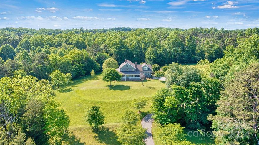 Breathtaking property!  Custom built home perfectly designed with elegance and comfort.  From the moment you walk in, you will notice all the extras that this home has to offer and get that warm feeling that a farmhouse brings.  Nothing was spared in this home starting with the 10 ft deep wraparound porch.  Beautiful 6" white oak wood floors.  Real wood bead board.  Country kitchen with island.  2 fireplaces.  Luxurious primary suite.  Separate office or library with French doors.  Large screen porch.  Laundry room with chute from second floor.  On the second level you will find 3 comfortable bedrooms, 2 full baths, a den with wet bar and a bonus room.  Walk right up to the 3rd level where you will find an attic that has been insulated and plumbed making it easy to finish this to livable space.    This home sits in the middle of 11.6 acres and borders a creek.  Gated entrance and winding driveway. Room for garden, outdoor toys and all your animals.  Country living at its best!