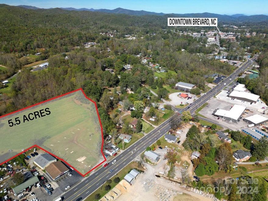Roughly 1 mile from Main Street Brevard on US Hwy 64, this 5.5 acre parcel has endless possibilities. Made up of two parcel numbers, the first parcel is 1.39 acres, has 115 feet of frontage on the four lane highway, and is zoned Neighborhood mixed use. The other parcel is 4.11 acres, zoned residential G4, level, cleared, and has 424 feet of frontage on Nicholson Creek. It is all in the ETJ. If you are looking for a highly visible commercial parcel on a road with a high traffic count, close to downtown, plenty of room for a storage yard or expansion in the back, and easy access, this might be the one. It would also make a great parcel for a development. This parcel offers many avenues to make it an income producing property. It is a must see.