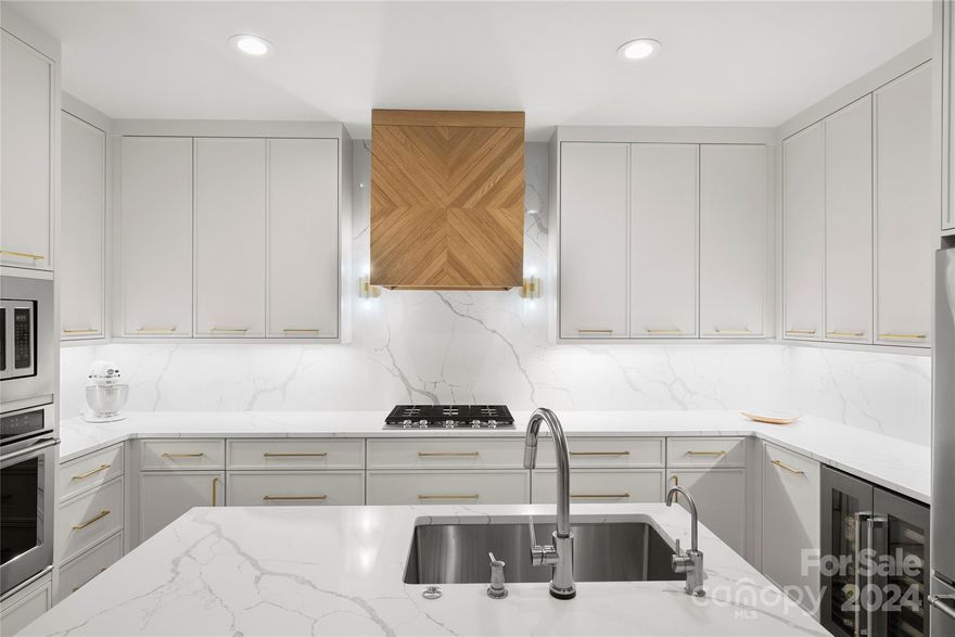 Gorgeous top floor condo in historic Fourth Ward. Stunning gut renovation totaling @$230,000 completed in 2022.  New-wide plank white oak flooring, incredible modern kitchen with custom cabinets, quartz countertops and backsplash, dual zone wine fridge, gas cooktop & a custom-made vent hood.  All new bathrooms with neutral tile and quartz counters. New modern lighting and hardware, solid doors throughout. 11 foot ceilings in living area and brick terrace, 9 foot ceilings everywhere elset. New cast concrete fireplace surround with on-trend gas cannon ball insert. The private brick paver porch overlooks leafy Fourth Ward and has year-round breathtaking sunset views. The porch has a natural gas port for a grill & a faucet. The over-sized primary bedroom has two customized closets. Lovely secondary bath. More storage on same floor. H20 heater (2023) Google fiber 1G. Two deeded parking spaces, gated entrance w/security cameras & keypad door entries@bike storage in the garage. Quality!