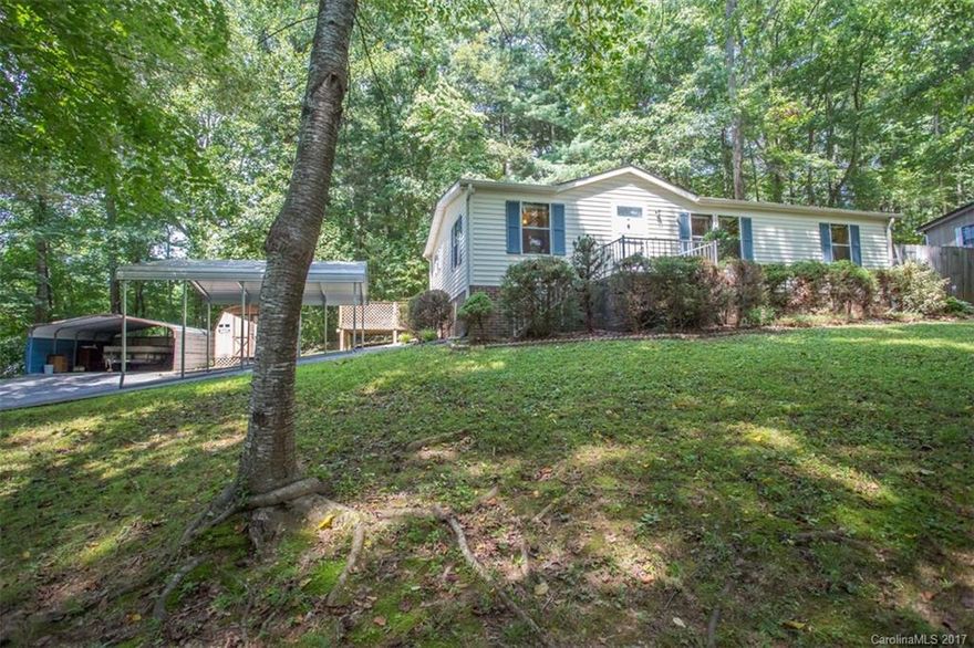 Super cute, well maintained 2 bedroom 2 bath home in established community. Solid wood floors, newer architectural roof, tiled kitchen and baths. Semi-private tree lined parcel with partially fenced yard. Large 16 x 22 deck with storage building and covered carports. Great location with quick access to Hendersonville, Brevard or Asheville. Excellent starter home for young family or retirees looking to downsize, or would make excellent investment property in our market.
