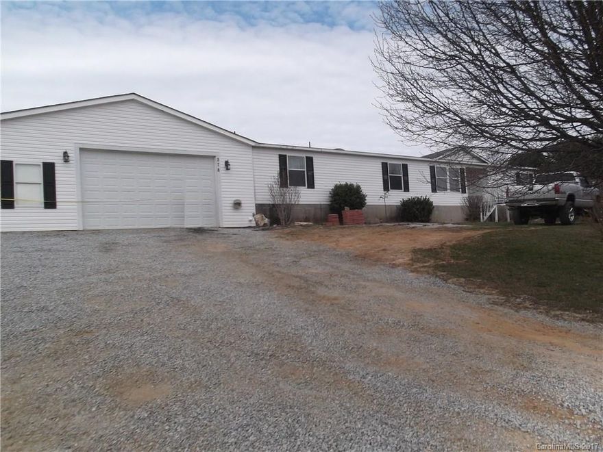 A RARE FIND- 2.5+/- zoned R2R with no deed restrictions.  Wonderful family home, some level land, garden area, sloping, fenced pasture.  Large open floor plan, split BR, large back covered deck, extra large garage.  Mountain views! If you want a mini-farm or just a place to play, this is it.  Also has room for a second building site.