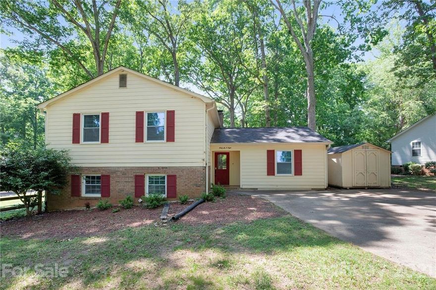 This Gastonia two-story corner home offers a patio, and a fireplace.