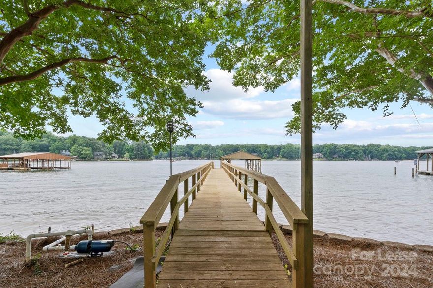 Waterfront Home Available Immediately! Nestled on the tranquil shores of Lake Norman, this charming 3 bedroom and 2 bathroom waterfront cottage offers a perfect blend of rustic charm and modern comfort. Boasting panoramic main channel sunset views of the lake and surrounded by lush greenery, this idyllic retreat promises a serene escape from the hustle and bustle of everyday life. This quaint home has 2 updated full bathrooms and an updated kitchen. No HOA with almost 3/4 acre lot, complete with a lush backyard, established trees, a floating dock, and a covered boat slip, and 200' of shoreline. Property has outside dog pin with a chicken coup for dogs or other livestock. Oversized gravel parking area for toys, RV, Boat, ATV etc. Tenant responsible for lawn maintenance and leaf removal. Must have three times monthly income and credit score 650+.  Application fee applies to all persons 18 and over.  No smoking; pets conditional. Prefer 1 year lease but will consider other lengths.