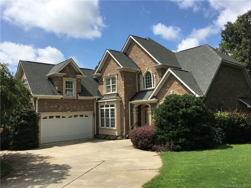 Elegant custom home, full brick, circular drive on 1.28 acre lot with private, wooded backyard in an executive neighborhood. The main level features hardwood floors, two story entry foyer and extensive mill work. Gourmet kitchen with custom cabinetry flows into an open floor plan great room wired for surround sound. Luxurious master suite on main level with direct access to a beautiful oversized deck. Second floor has three large bedrooms, two full baths and huge bonus room. Fort Mill Schools.
