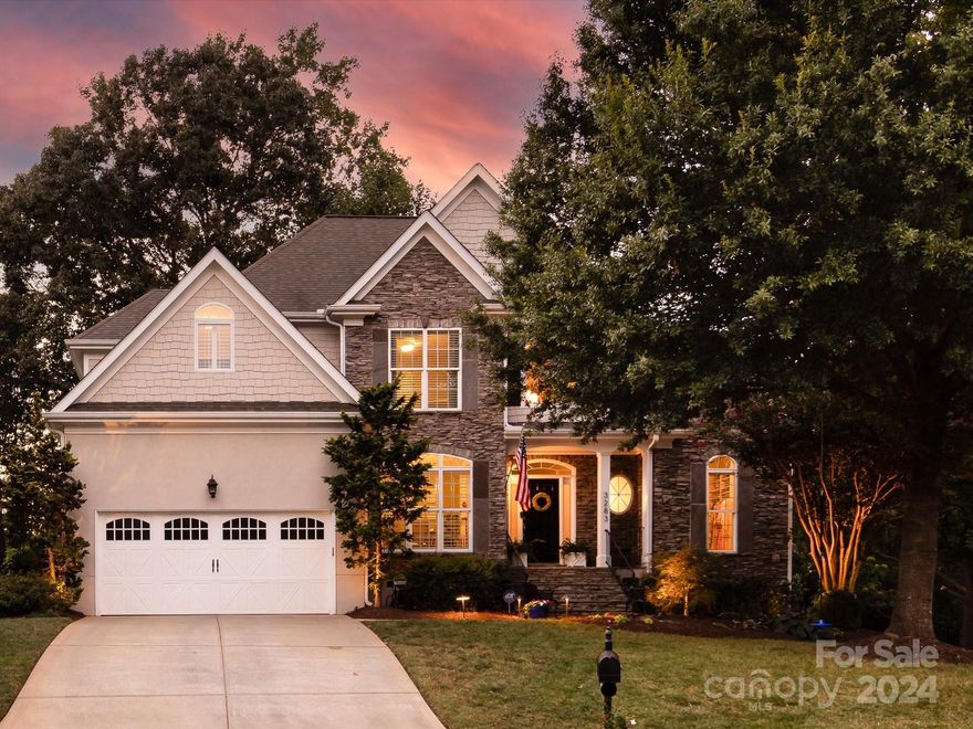 This move-in ready 4-bed, 2.5-bath home is nestled in a peaceful cul-de-sac and located in the award winning Fort Mill School District! Be greeted by lush landscaping as you walk up to the inviting covered porch & step inside to find that no detail was missed! The open floor plan brings together a two-story living room, keeping room, dining, and an updated kitchen on the main. The kitchen boasts stainless steel appliances, a gas range, double oven, marble backsplash, granite countertops, & breakfast bar. Enjoy top of the line finishes such as hardwood floors throughout, plantation shutters, two stone fireplaces, and built-in closet systems for every bedroom. A spacious primary suite is located on the main while upstairs you will find three generous bedrooms with new carpet and full bath. End your tour on the expansive back deck overlooking a serene hardscape patio w/ fire pit and water feature. This home is complete with in-ground irrigation & is the perfect oasis for your family.