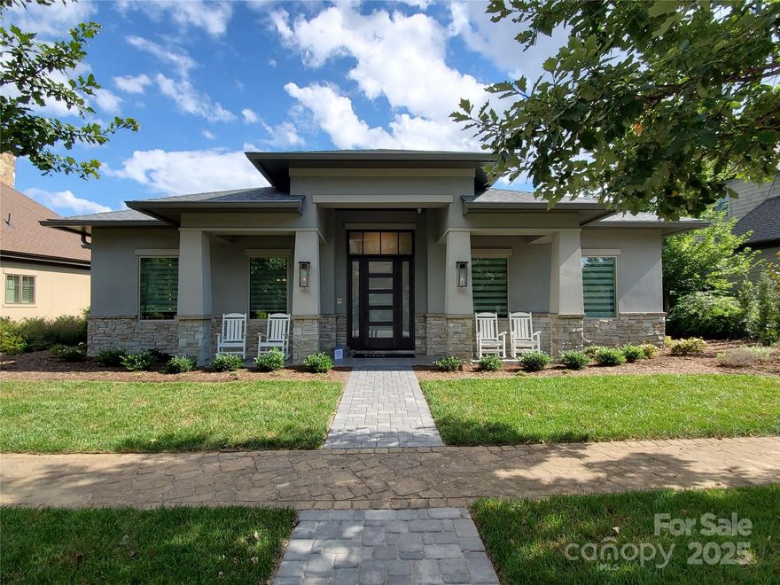 This stunning property seamlessly blends modern comfort with nature’s beauty. The charming home features a welcoming facade and beautifully landscaped yard, providing a serene setting. Inside, the one-level open-concept living area boasts high ceilings and expansive windows that fill the home with natural light. The spacious living room flows into a modern kitchen equipped with high-end appliances and a cozy breakfast nook. With three generously-sized bedrooms, including a luxurious master suite, each with an en-suite bathroom, this home offers ample space for relaxation for you and your guests. The expansive rear patio, complete with a fireplace, is perfect for outdoor dining or enjoying morning coffee while listening to the soothing sounds of nature. Conveniently located across from the Wellness Center and just a short drive from Asheville, you can easily access artisanal shops, renowned restaurants, and outdoor activities in the Blue Ridge Mountains.