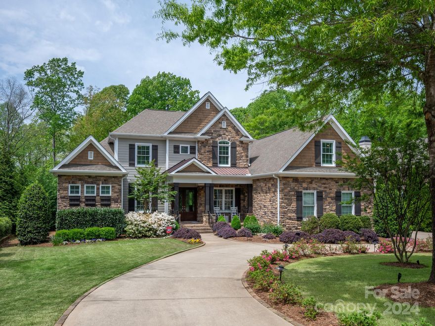 Amenity-rich Springfield is a premier neighborhood offering pools, clubhouse, playgrounds, tennis, pickleball, walking trails, activities, fitness center, public golf course, and award-winning schools! This Arthur Ruttenberg home has everything you desire and is an entertainers dream. Open concept floorplan with updated kitchen and baths, hardwood floors throughout entire home. Heavy moldings and tons of storage. 51' pool with jumping Rock and hot tub will accommodate fun pool parties. The circular driveway is an added bonus. A separate office allows you to work from home. Two bonus rooms upstairs with an observation deck to view the sunset and golf course. Three upstairs bedrooms have ensuite bathrooms. Backs to HOA owned land that is completely wooded and private. HOA dues include annual membership to Anne Springs Greenway located across from neighborhood that has 2,100 acres of nature preserve with countless activities; hiking, biking, horseback riding to picnics, kayaking and more.