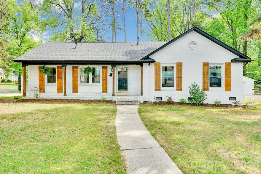 Charming white brick ranch in the heart of East Charlotte! This beautifully updated home blends timeless character with modern touches, featuring original hardwood floors that have been expertly refinished throughout. Offering 3 spacious bedrooms and 2 full bathrooms, the home boasts a functional layout perfect for everyday living and entertaining. Enjoy your morning coffee in the light-filled sunroom, a perfect spot to relax year-round. Situated on a desirable corner lot, the property also features a large, fully fenced backyard—ideal for pets, play, or hosting gatherings. Previously renovated with thoughtful upgrades, this move-in ready gem is full of warmth, style, and classic appeal.