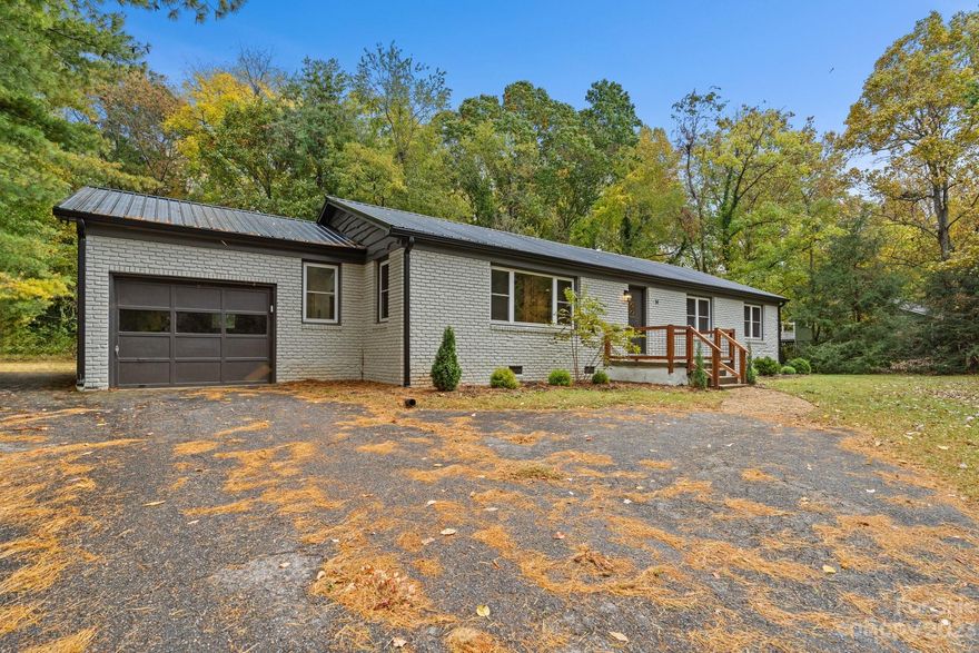 Priced below most recent appraisal!!! Check out this recently remolded rancher just seconds from town! The home remodel was completed in 2022, before the sellers purchased in 2023. This spacious home has all the updates in an unbeatable location. The shell of the home has new metal roof and gutters, fresh paint inside and out, new windows throughout and new insulation in the crawlspace & all new HVAC Heat Pump. Inside you'll find updated lighting and fixtures, hardwood floors, new tile in the kitchen and bathrooms, even the massive laundry room got new flooring! All new kitchen with upgraded appliances, new cabinets, stone countertops and stylish backsplash leave any home cook smiling! Fireplace is ventless propane ready for you to bring your own log set. Massive level and partially fenced yard space gives you tons of options & perfect for outdoor play! Crawlspace professionally fully encapsulated! 6 minute drive to the Blue Ridge Parkway, WNC Nature Center, and Highland Brewing.