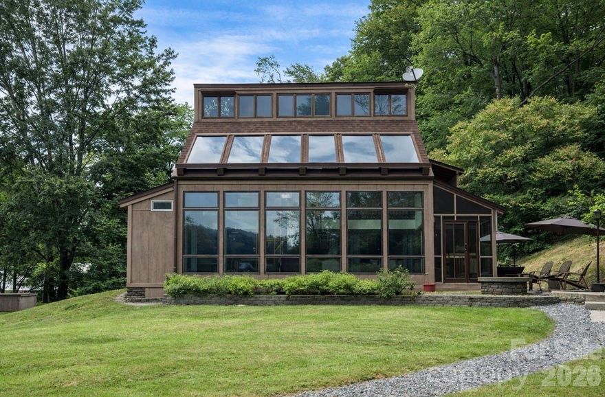 New windows in the sunroom! Experience the rare harmony of nature, comfort, and self-sufficiency at this beautifully crafted passive solar home nestled above the banks of Beaver Creek. Tucked away on over three acres, this property offers an escape with the sounds of the creek and birdsong. Designed with sustainability and efficiency in mind, the home’s south-facing orientation and large picture windows invite in natural light and passive warmth throughout the winter. The layout flows effortlessly, with thoughtful materials, radiant sunlight, and seamless indoor-outdoor living that connects you with nature at every turn. Step outside to explore winding trails, two garages, balcony, and patio for picnics. You’ll find a hidden camping retreat, and usable land ideal for gardening, homesteading, or soaking in nature. A scenic drive brings you into town with ease, but you’ll feel worlds away. Whether you're looking for a full-time home or eco-minded getaway this home offers unparalleled connection with the outdoors.The home is not in a flood zone and has never flooded during any storms. 2 bedroom septic with a bonus room on the main level that could be used for a home office or bedroom. Come see this gem!