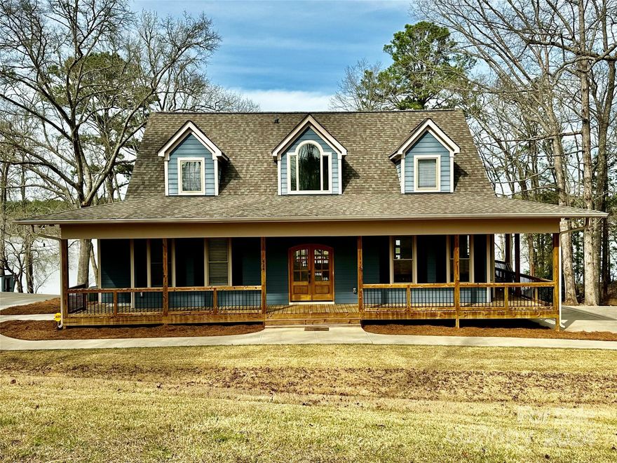 Gorgeous home built in 2018 in the most peaceful, private setting you can imagine! The great room centers around a towering stone gas fireplace and massive glass doors that look out onto the pristine quiet of Taylor Creek. The huge stone wood burning fireplace on the covered porch is original to the property and is sure to bring countless memories of evening entertainment. The wrap around porch offers many opportunities to enjoy nature and water views. Inside, you'll love the hardwood floors and custom wood cabinetry. The kitchen is stunning with dramatic stone counters, pro appliances and gas cook top with island vent. The walk-in pantry features more custom cabinetry with pull out drawers and extra storage. The master and den/home office that could also double as a 4th sleeping space are all on the main level. Upstairs, there are 2 guest rooms and a shared full bath with 2 vanities. Outside, there is a huge concrete pad for parking, a new pier and a perfect sandy beach for swimming!