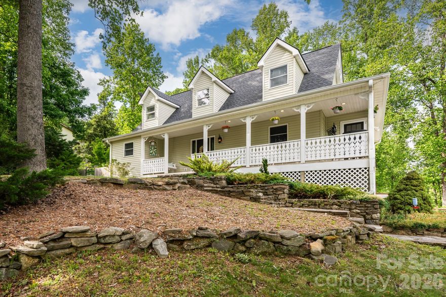 Updated Cape Cod style home surrounded by beautiful mountain scenery, offering a peaceful setting both inside and out. This well maintained home features a main level primary suite with a large walk in closet and updated bath. Upstairs offers two spacious bedrooms with charming details and stained glass salvaged from a historic downtown Hendersonville home.
The large kitchen includes a breakfast bar and eat in dining area with plenty of natural light. A fully finished basement provides flexible space for a playroom, home office, gym, media room, or guest area.
Enjoy mountain living from the large covered front porch with plenty of space for rocking chairs and morning coffee. The fenced backyard features a stone patio with a fire pit, room for gardening, and a chicken coop, creating the perfect setup for outdoor living and entertaining.