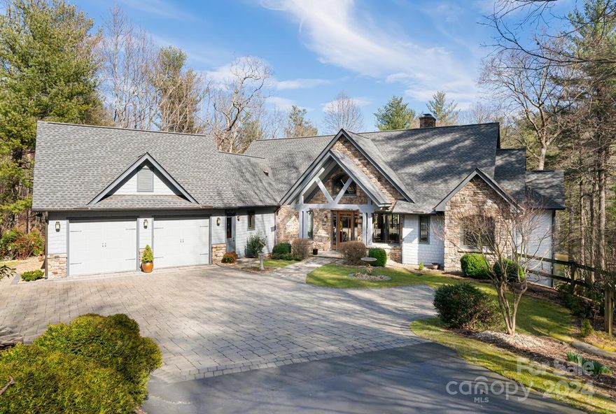 Distinctive luxury, custom built home in prestigious Kenmure-a gated golf course community. Premier location on Kenmure lake, nestled on 2.7 private acres with amazing lake, golf course and long range mountain views. Prepare to be captivated by this exquisite home that boasts an array of high-end amenities throughout. Impressive floor to ceiling stone fireplace along with 8' solid Knotty Alder doors leads the way to the relaxed luxury living this home provides.. Attention to details and the finest appointments are noted the moment you walk through the door. Extraordinary living spaces including the gourmet kitchen, open dining room, breakfast room, great room, bar area and stunning spa-like primary suite. Perfect for entertaining. Outdoor enthusiasts will fall in love with this park-like setting while relaxing on the covered deck, screened porch, patio or by the waterfall enjoying the natural setting and views. Path leading around lake to clubhouse. Imagine waking to these views!