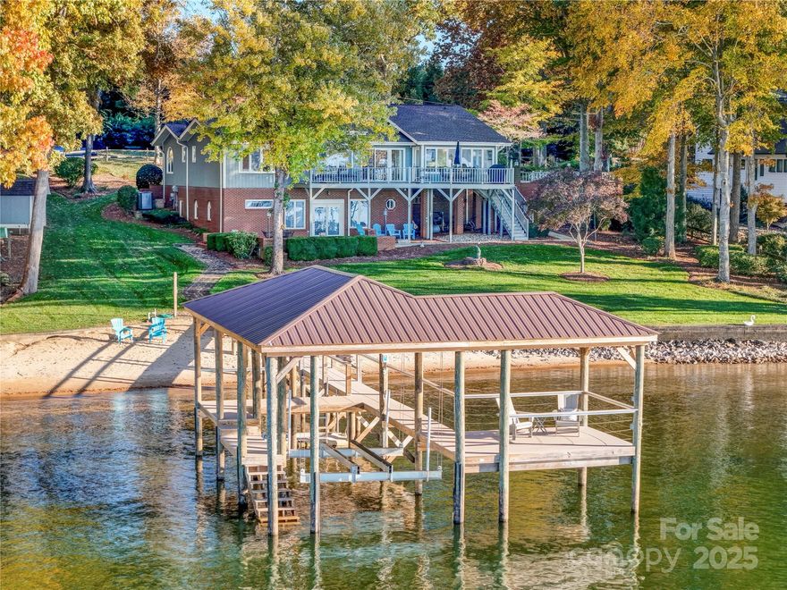 UPDATE -- Multiple offers received. OFFER DEADLINE -- 5pm, 11/9/25. BIG water views await in this lovingly maintained home on beautiful Lake Norman. Used for years as a weekend and holiday retreat, 350 Normandy offers two levels of living, all oriented toward the water. The spacious lot features a gentle slope to the shoreline, a private sandy beach, and a 2021 dock with composite decking, two lounging areas, a boat lift, and a jet ski dock. Inside, the living room, dining area, and kitchen flow together, perfect for entertaining and open to the sunroom with walls of windows. There are two main-floor bedrooms, including the primary suite with lake views. Downstairs, you'll find a large family room with a bar, a bedroom and bath, plus a flex room currently used as an additional guest space. Relax on the upper deck, accessible from both the dining area and sunroom, or unwind on the lower patio. Additional highlights include a two-car garage and ample driveway parking. The home is sold furnished (with a few exceptions), down to the dishes and silverware; just bring your clothes and start enjoying all that lake life has to offer. Showings begin Saturday, 11/8, with an open house from 1–3 PM. Welcome home!