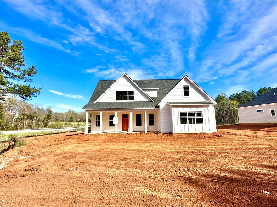 Don't miss your chance to get into this gorgeous new construction by custom home builder Tom Ras. The Thomas Farmhouse plan will feel like home with its welcoming covered front porch and solid wood craftsman front door. High ceilings, tall baseboards & wood flooring are just some of the details that will get your attention! Situated on a 1.6 acre lot, you have plenty of room to enjoy the setting. This open concept offers a primary suite on the main level with custom closet systems, trey ceiling and a beautiful spa like bath.  You'll find 3 more bedrooms on the upper level.  All of the bathrooms have quartz countertops, tile bath or shower and custom lighting. Your great room has a coffered ceiling and fireplace that can be enjoyed from the kitchen as well.  The kitchen is bright w white cabinets, large center island, stainless steel appliances, quartz countertops, under cabinet lighting and recessed lighting. Enjoy the evenings from your covered patio. Just minutes from the University!