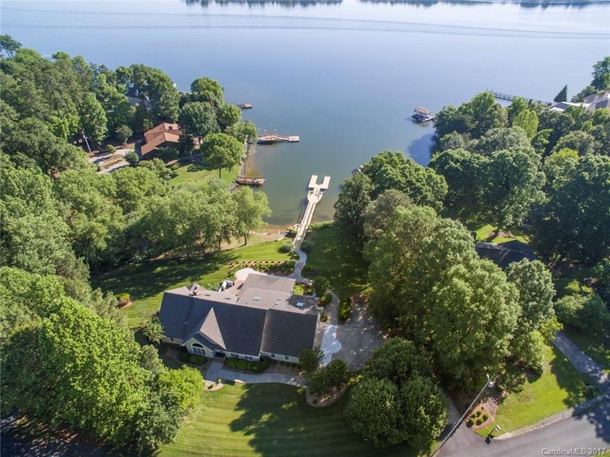 1.69 acres, Main Channel, Gently Sloping Lot! It doesn't get much better!  Enormous screened porch and brick patio, recently rebuilt dock system on deep water.  Open floor plan, 3 car garage, 2 walk-in pantries, built-in SubZero, Wolf and Jennaire updated appliances, wood floors on most of main floor. Stone fire place with gas logs, amazing landscaping, over 4000 square feet! NO HOA DUES!  Additional unfinished area could be made into a bonus room if you need more space.