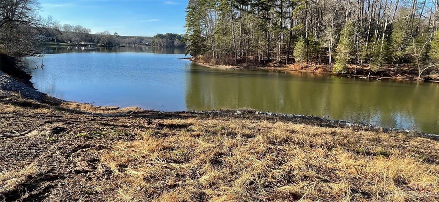 .81 Acre waterfront lot with 141' road frontage and 107' waterfront shoreline on a gently sloping, partially wooded, dock-able lot located in McLean's new waterfront custom homes development of Hunts Point. Lot orientation is Westerly (sunsets) with beautiful long range open water views. (see photos) Hunts Point HOA maintained street. Current owner has completed Rip-Rapping shoreline stabilization along with stone steps installed that descend to a potential small future beach area. Lot is across a small bay area facing the undeveloped waterfront property of the Land Conservation of the Carolina Thread Trail and the Stowe Botanical Gardens. Lot could accommodate either crawl or walkout basement home designs.