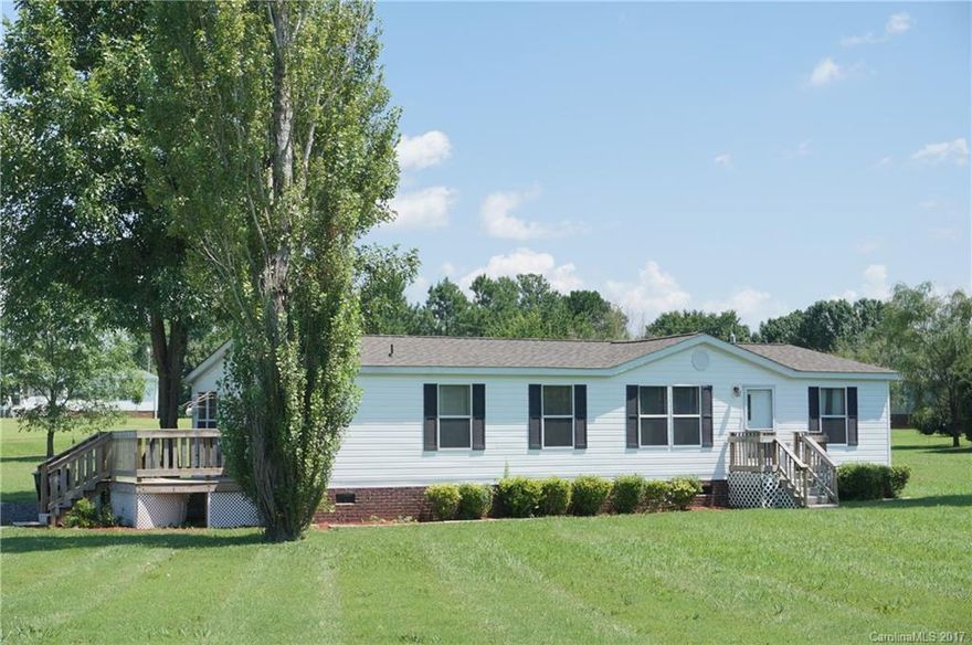 Oh so nice!  Located in a beautiful country setting, this doublewide mobile home on 1.55 acres is ready to move right in to.  3 bedrooms, 2 baths, living room and dining room with vaulted ceiling, great kitchen, breakfast room, split bedrooms, master bath with garden tub.  Very desirable area.