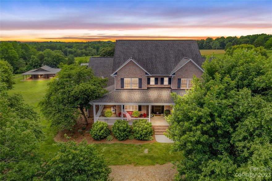 Enjoy the peace & tranquility that life in the country can offer & still be close to everything! Check out this custom-built, full brick home w/unfinished basement on almost 12 acres of beautiful pastures & views for miles! Included are 2 additional lots that could be sold or built on, offering endless possibilities! Large wrap-around porch w/ ceiling fans, rear decks, & screened-in back porch are perfect for entertaining & soaking in the amazing sunsets! Open floorplan w/ built-in shelving, gas logs, custom kitchen w/ granite countertops, under cabinet lighting & SS appliances. Primary suite, guest room/office, laundry & mudroom located on main level. The upper level features 2 bedrooms, bathroom & large Bonus/Media or Family Room. Perfect for animal lovers & outdoor enthusiasts w/fenced-in pasture & creek! Concrete floor barn w/ cool/tack room & loft, oak stalls & SS sink w/ floor drain. A pole barn, custom-built chicken coop & aviary help round out this amazing property! New HVACs!