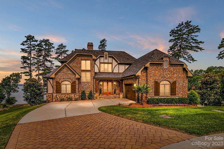 Amazing custom built waterfront home in highly sought after Reflection Pointe! Built in 2018, this home features 4 BRs, 4 1/2 BAs,  an open floor plan, & a screened porch offering main channel & water views from almost every room in the house! There is great outdoor living space, both on the main floor & lower level to enjoy spectacular sunsets and for entertaining. Located in a cul-de-sac, this home offers a private and protected setting. The lower level is an entertainers dream with a great room & bar, wine room, bedroom with full bath, study and plenty of basement storage for lawn & lake toys. The downstairs covered patio has plenty of room for seating and dining. A large fire pit area is perfect for finishing up the day on those cool fall nights. A private, covered fixed boat dock with automatic lift is ready for your favorite watercraft. Bring your pickiest buyers for this move-in ready home. This is lake living at its finest!  *Please see drone video included in virtual tour*