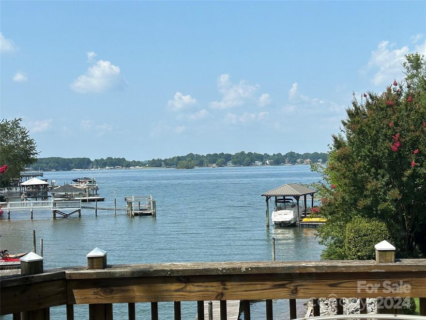 Nestled in a serene waterfront cove, this spacious home offers tranquility and luxury. Boasting 3 bedrooms and 3.5 baths, it features a sun-drenched sunroom and loft, flooding the 3800 square feet with natural light. Enjoy picturesque views from the wrap-around decking and front porch, perfect for relaxation. Situated on a cul-de-sac with an oversized .79-acre lot, the large backyard provides ample privacy. This oasis is ideally located off exit 28 in Cornelius, promising convenience and accessibility. Experience waterfront living at its finest in this coveted location.  House is being sold as is. Gas line easement is at the rear of the property.  Land in easement cannot be built on and will always remain open as long as the pipeline exists. Sewer is at the street; buyer may pay to connect. County can not find record of the original septic permit to verify number of bedrooms that they house was originally permitted for.