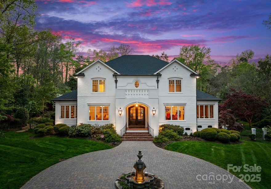 Tucked into the lush landscape of Highland Forest Estates, this custom-built gem by Gerrard Builders and input by renowned architect Don Duffy offers over 7,200 square feet of timeless design and luxury. Situated on a nearly 2-acre corner lot near Charlotte’s premier private schools, this 6-bedroom, 6.5-bath retreat boasts an updated gourmet kitchen, a main-level primary suite with updated spa-like bath, dual walk-in closets, and a private dressing room. The home features a separate guest apartment with mini kitchen and bath, a fully finished basement with theater, 19-foot custom bar, and an oversized she shed. Step outside to a resort-style backyard with a heated saltwater pool, hot tub, cabana, waterfall, and wood-burning fireplace—surrounded by botanical gardens for year-round beauty. With two driveways and extensive updates throughout, this home defines luxury living. Located on a picturesque street, just minutes to SouthPark shopping, dining, and major highways for easy commuting.