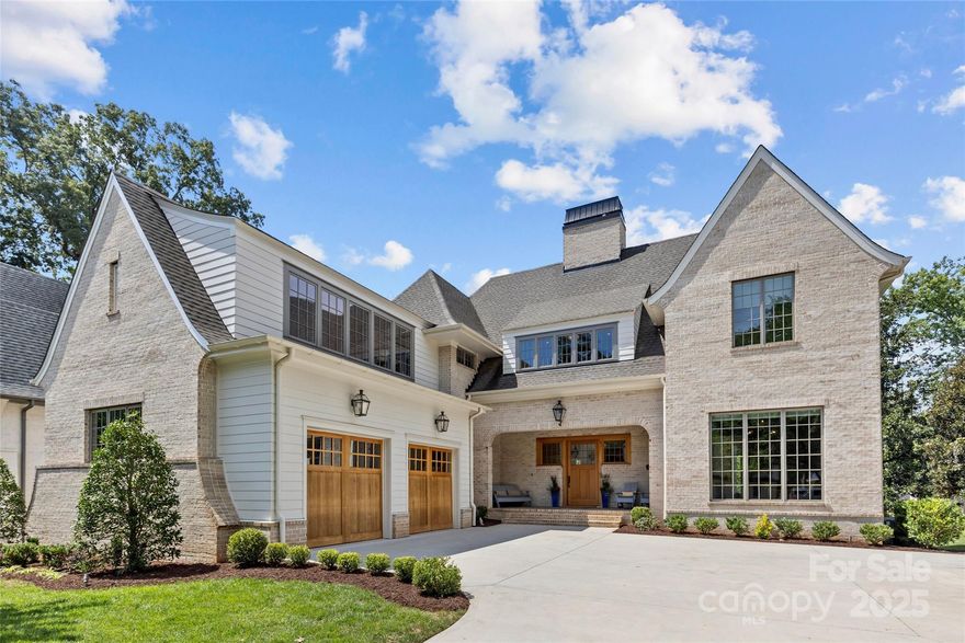 Exceptional custom home in sought-after Myers Park, designed by Christopher Phelps and built by McCormick Custom Construction in 2021/2022. Situated on a sprawling .70-acre lot along the Sugar Creek Greenway, this 5,600+ sq/ft residence offers 5 bedrooms and 5.2 baths. Elegant details include 10’ ceilings on the main level, white oak hardwoods, custom millwork, and designer lighting and finishes. Chef’s kitchen boasts SubZero/Wolf/Cove appliances, white quartz countertops, custom cabinetry, and extensive scullery. Open concept blends kitchen with sunlit dining room and family room with cast stone gas fireplace. Main-level primary suite impresses with vaulted ceiling, spa-like bath, and incredible custom walk-in closet. Upstairs offers 4 en-suite bedrooms, large bonus room, open loft, flex space, and second laundry room! Covered rear porch with bluestone pavers, heaters, retractable screens, and wood-burning fireplace overlooks the flat, fenced yard. Enjoy living in a pristine, like-new home in one of Charlotte's most desirable neighborhoods just minutes from Freedom Park!