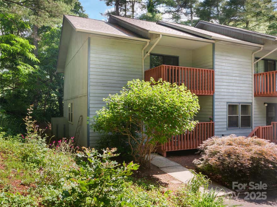 End-unit townhome in in the desirable Ivy Hills community, just 5 minutes from downtown Waynesville. This 3-bed, 3.5-bath, two-story home with finished basement offers spacious living with the main level featuring an open floor plan with galley kitchen, flowing into bright great room with gas logs (not connected) and dining areas. Enjoy a covered front porch, large rear deck, and lower-level patio for outdoor relaxation. Built with 2x6 construction, laundry closet and more. Nestled in a parklike setting with 2 assigned parking spaces, this home blends comfort with serene surroundings. Perfect for those seeking convenience and community!