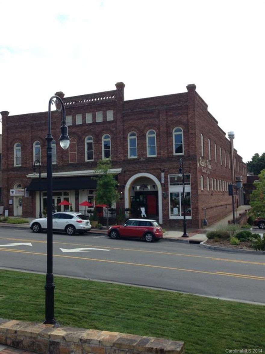 BEAUTIFUL HISTORICAL SPACE IN DOWNTOWN. The interior of the building has been renovated with new flooring, bathrooms fixtures, and heating/cooling systems. The parking lot beside the entrance on N. Center St. can be used for client/customer parking.