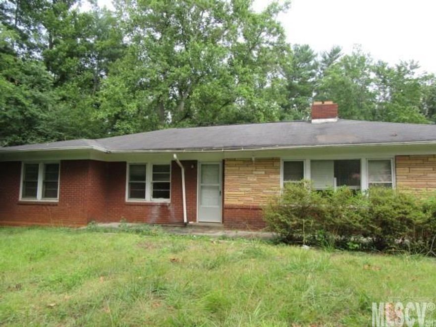 Solid brick home with full basement. Home sits on over 1 acre on a corner lot. Lots of home for the money. Home features hardwood floors and large living room with 3 bedrooms and 1 bath. Property consists of 4 parcels. Priced well below tax value.